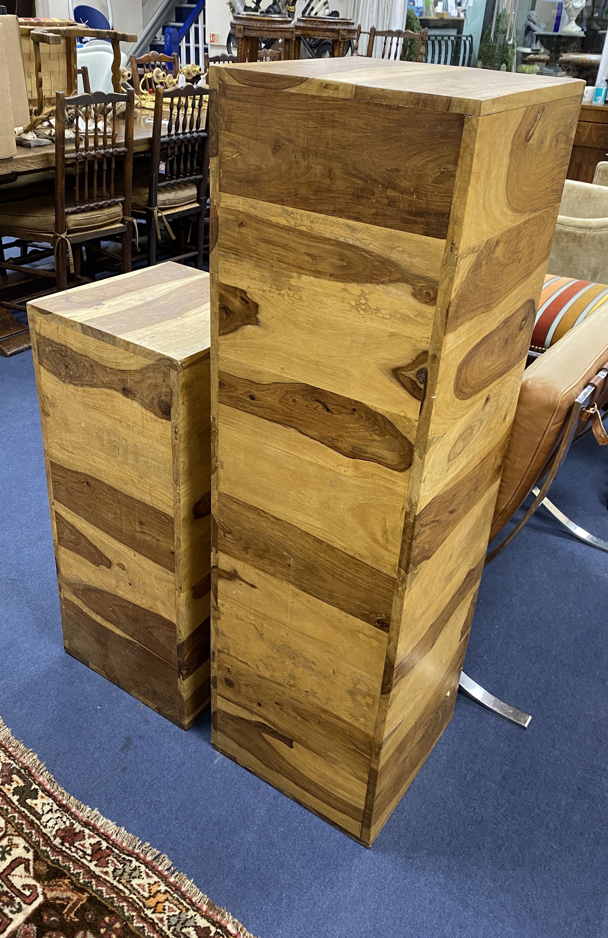 Two olive wood wooden plinths, larger height 122cm